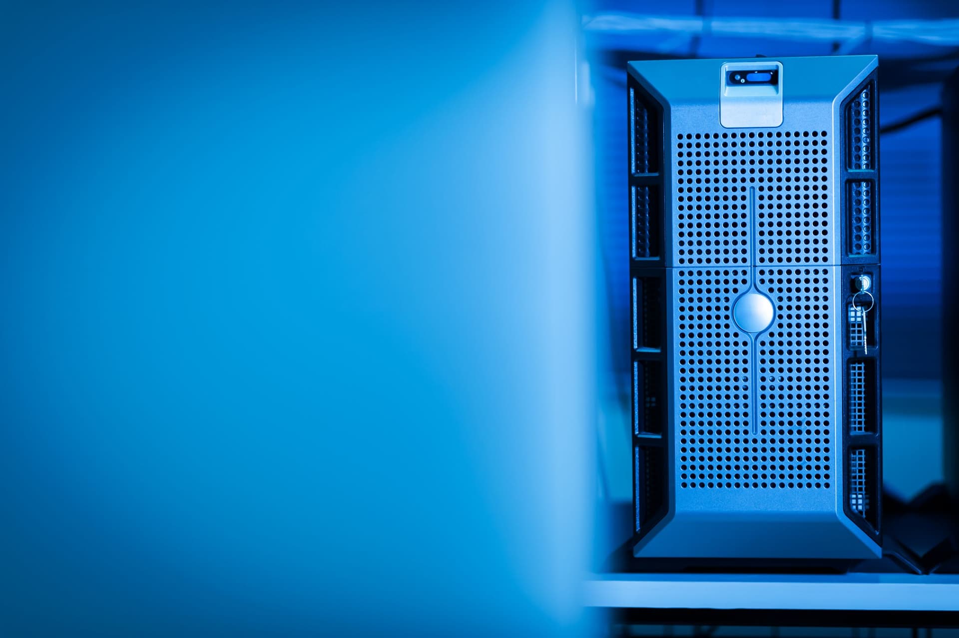 A server unit standing in a blue-lit data centre